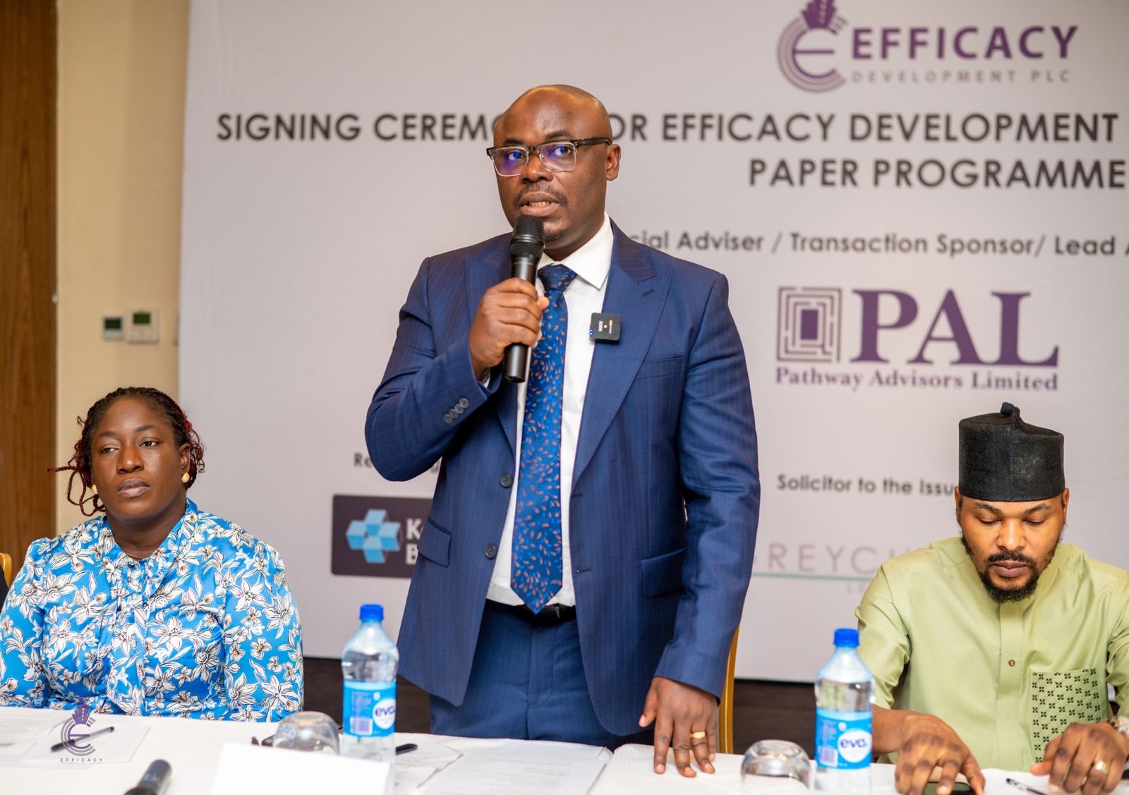 Efficacy executive speaking at the signing ceremony for the Efficacy Development commercial paper programme