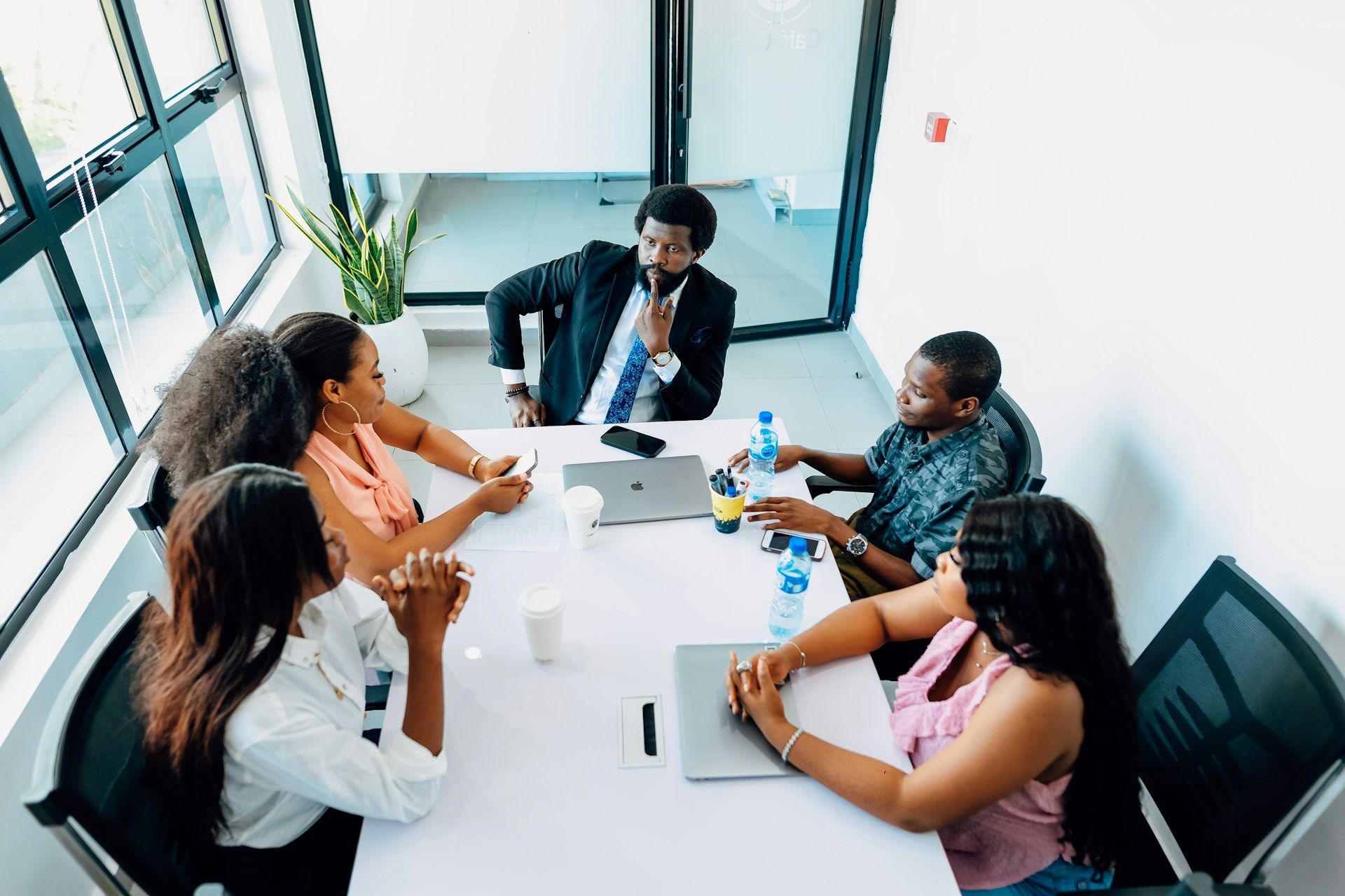Advisers meeting around a table to review plans and figures