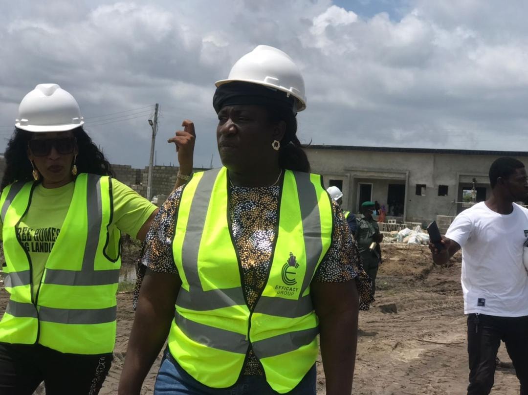 Efficacy team wearing hard hats and safety vests at a construction site